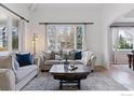 Bright living room features neutral furniture, a rustic coffee table, and a large window at 4094 Bimini Ct, Boulder, CO 80301