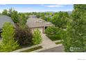 Spacious home featuring lush landscaping, mature trees, well manicured lawn, and a beautiful neighborhood at 4444 Fireweed Trl, Broomfield, CO 80023