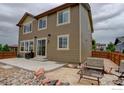 Exterior shot shows the backyard with patio, landscaping, and access to the home at 6356 Twilight Ave, Firestone, CO 80504