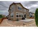 A charming home exterior featuring a stone patio and neutral siding at 6356 Twilight Ave, Firestone, CO 80504