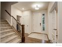 The foyer welcomes with hardwood floors, stairs, and a bright entryway at 6356 Twilight Ave, Firestone, CO 80504