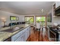Spacious open concept kitchen with island, granite countertops, and eat in dining area at 827 Maxwell Ave # H, Boulder, CO 80304