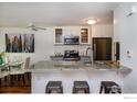 Bright kitchen features a breakfast bar with seating, granite countertops and stainless steel appliances at 827 Maxwell Ave # H, Boulder, CO 80304