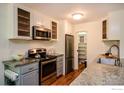Well-lit kitchen showcasing stainless steel appliances, granite countertops, and ample cabinet space at 827 Maxwell Ave # H, Boulder, CO 80304