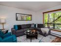 Cozy living room with sectional couch, large window, and stylish decor, perfect for relaxation at 827 Maxwell Ave # H, Boulder, CO 80304