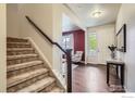 Welcoming entryway featuring hardwood floors, staircase, and view into the living room at 853 Jenny Ln, Berthoud, CO 80513