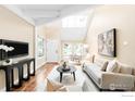 Cozy living room boasts vaulted ceilings, skylights, plush seating, and hardwood flooring at 93 Benthaven Pl, Boulder, CO 80305