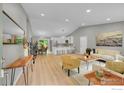 Open-concept living space with sleek wood flooring, neutral walls and modern decor at 106 S Madison Ave, Louisville, CO 80027