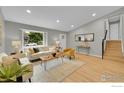 Bright living room featuring a large window, wood floors and modern furnishings at 106 S Madison Ave, Louisville, CO 80027