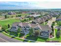 Aerial view of a well-maintained neighborhood with green spaces and manicured lawns at 10818 Cimarron St # 1203, Firestone, CO 80504