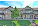 Charming townhome featuring a well-manicured lawn and stone accents at 10818 Cimarron St # 1203, Firestone, CO 80504