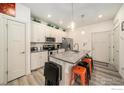 Bright kitchen boasts granite countertops, stainless appliances, and a functional layout at 1099 Spartan Ave, Berthoud, CO 80513