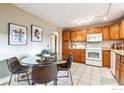 Kitchen with tile floor, dining table, and oak cabinets at 1101 Spruce St, Louisville, CO 80027