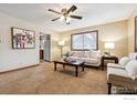 Cozy living room featuring neutral walls, carpet, ceiling fan, and a comfortable seating area at 1101 Spruce St, Louisville, CO 80027