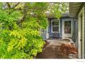 Charming front porch with a seating area near a landscaped yard at 11096 Claude Ct, Northglenn, CO 80233