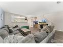 Spacious living room features a large sectional sofa and adjoins the kitchen at 11096 Claude Ct, Northglenn, CO 80233