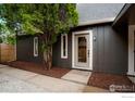 Welcoming front entrance featuring a glass door, mulch landscaping, and neutral accents for a cozy feel at 133 Placer Ave, Longmont, CO 80504