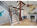 Inviting living area with exposed beams, a fireplace, and a modern staircase at 1540 Sumac Ave, Boulder, CO 80304
