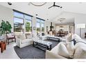 Spacious living room with vaulted ceilings, large windows, and modern furnishings at 1563 Spring Creek Xing, Lafayette, CO 80026