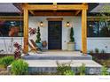 Inviting front porch with wooden pergola, stylish chairs, and decorative plants at 1801 Redwood Ave, Boulder, CO 80304