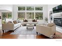 Bright living room with a fireplace, large windows offering scenic views and neutral contemporary furnishings at 1946 Lefthand Canyon Dr, Boulder, CO 80302