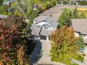 Aerial shot of a beautiful home surrounded by lush, mature trees in a serene neighborhood at 2001 Coralbells Ct, Longmont, CO 80503