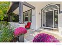 Inviting front porch with cozy seating, vibrant flowers, and classic architectural details at 2001 Coralbells Ct, Longmont, CO 80503