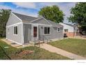 Charming single-story home with a well-maintained lawn and inviting front entrance at 201 4Th St, Frederick, CO 80530