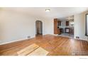 Spacious living room featuring gleaming hardwood floors and natural light at 201 4Th St, Frederick, CO 80530