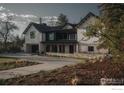 Stately home showcasing stone accents, a manicured lawn, and inviting curb appeal at 2100 Kohler Dr, Boulder, CO 80305