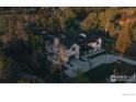 Expansive home featuring a basketball court, manicured landscaping, and stunning architecture at 2100 Kohler Dr, Boulder, CO 80305