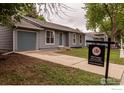 Charming single-story home with well-maintained lawn, driveway and attached garage at 2230 Lincoln St, Longmont, CO 80501