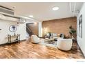 Open living room featuring hardwood floors, exposed brick, and lots of natural light at 2245 Blake St # D, Denver, CO 80205