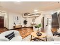 Open living room with exposed pipes and hardwood floors at 2245 Blake St # D, Denver, CO 80205