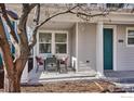 Inviting front porch features space for outdoor seating with a modern table set on the patio at 2362 Xanthia Way, Denver, CO 80238