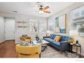 Bright and airy living room features stylish furniture and large windows, creating a welcoming atmosphere at 2362 Xanthia Way, Denver, CO 80238