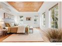 A lovely bedroom featuring a wood plank ceiling, hardwood floors, and multiple windows for great natural light at 2970 21St St, Boulder, CO 80304