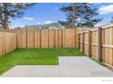 Landscaped backyard with wooden fence and concrete patio offers privacy at 3335 Broadway St, Boulder, CO 80304
