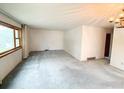 Bright living room with neutral carpet and large windows at 3490 Emerson Ave, Boulder, CO 80305