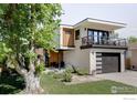 Beautifully landscaped yard and modern home with a balcony and a two-car garage at 3560 16Th St, Boulder, CO 80304