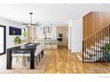 Open-concept living space with hardwood floors, a modern kitchen, and a dining area at 3560 16Th St, Boulder, CO 80304