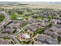 Beautiful aerial view of the community showcasing its layout, green spaces, pool and convenient location at 4795 Raven Run, Broomfield, CO 80023