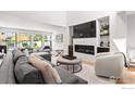 Bright living room featuring a fireplace, large sectional sofa, and abundant natural light at 4804 Briar Ridge Ct, Boulder, CO 80301
