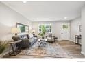 Bright and airy living room featuring modern furnishings, hardwood floors, and ample natural light at 518 Sunset Dr, Louisville, CO 80027
