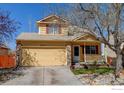 Charming home with a two-car garage, a cozy porch, and fresh landscaping in the front yard at 5241 E 128Th Way, Thornton, CO 80241