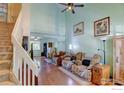 Spacious living room featuring high ceilings, hardwood floors, and a comfortable seating area at 5241 E 128Th Way, Thornton, CO 80241