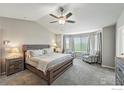 Spacious main bedroom featuring neutral tones, a ceiling fan, carpet flooring, large windows, and reading chairs at 682 Briar Dale Dr, Castle Pines, CO 80108