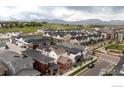 Aerial view of a residential neighborhood with modern homes and mountain backdrop at 730 Promenade Dr, Superior, CO 80027