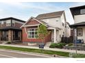 Well-manicured two-story home with a tidy front yard and inviting front entrance at 730 Promenade Dr, Superior, CO 80027