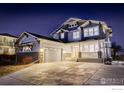 Charming two-story home with a two car garage, modern front porch and driveway at 785 Delechant Dr, Erie, CO 80516